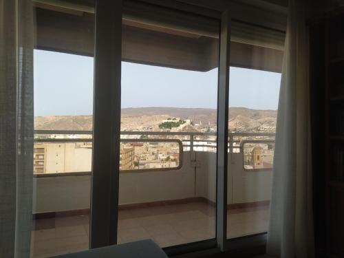 a room with a view of a city from a window at Fantástico ático en el centro de Almería in Almería