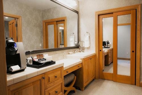 a bathroom with a sink and a large mirror at Premium Luxury Three Bedroom Suite with Two Hot Tubs apartment hotel in Park City