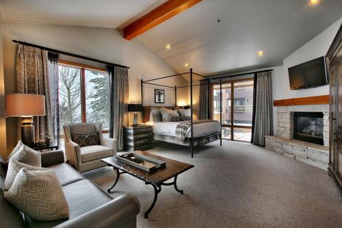a large living room with a bed and a fireplace at Premium Luxury Three Bedroom Suite with Two Hot Tubs apartment hotel in Park City