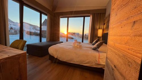 a bedroom with a bed with a view of the water at Albergo Vezzana in Passo Rolle