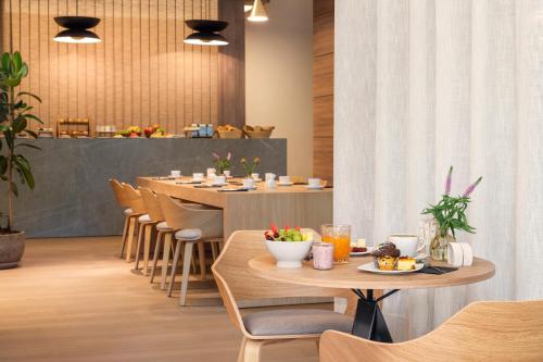 a restaurant with tables and chairs with food on them at Meliá Düsseldorf in Düsseldorf