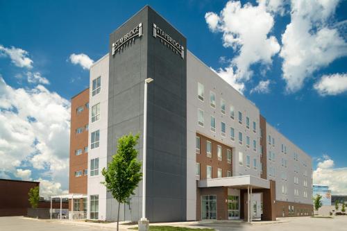 a building with a sign on the side of it at Staybridge Suites - Louisville - Expo Center by IHG in Louisville