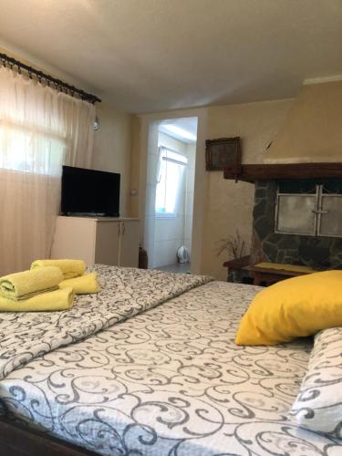 a bedroom with a bed with yellow towels on it at Kuca za odmor Davidovic in Despotovac