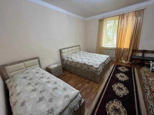 a bedroom with two beds and a window at Inexpensive house in Vanadzor