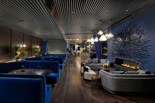 a lobby with blue couches and a fireplace at Hotel AMANO Covent Garden in London