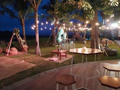 a party in the park at night with lights at Kori Maharani Villas - Lagoon Pool Access 4 in Siyut