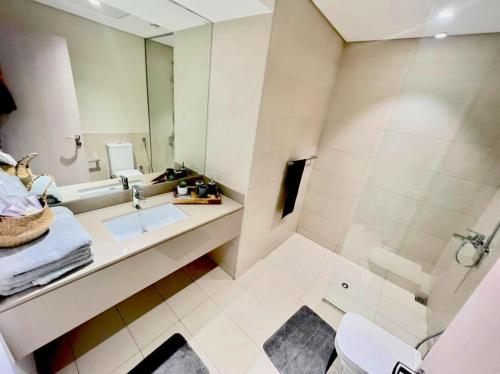 a bathroom with a sink and a shower at Yas Island canal 1- Formula 1, Entertainment, and Luxury Living! in Abu Dhabi