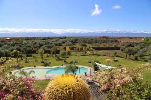an aerial view of a garden with a swimming pool at Riad Al Mendili Private Resort & Spa in Had Abdallah Rhiat