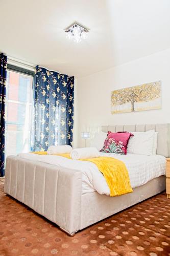 a large white bed in a room with a window at 2 Bedroom Chinatown Apartment in Birmingham