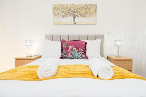 a bedroom with a white bed with towels on it at 2 Bedroom Chinatown Apartment in Birmingham