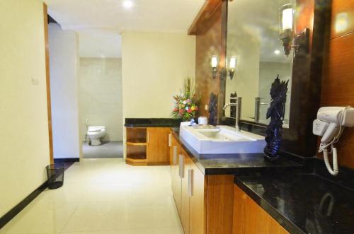 a bathroom with a sink and a toilet at Room in Villa - Kori Maharani Villas - One Bedroom Villa with Private Pool 4 in Siyut