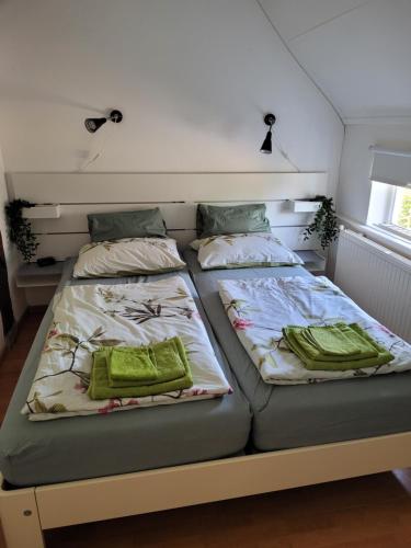 two beds sitting next to each other in a bedroom at Erve Niehof in Diepenheim