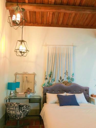 a bedroom with a bed and a mirror and a lamp at 依山行館 浪漫恬靜的落腳處 in Jincheng