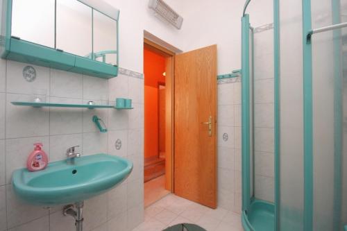 a bathroom with a sink and a glass shower at Apartments with a parking space Kraj, Pasman - 8288 in Kraj