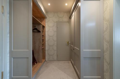 a hallway with a door and a walk in closet at Suvretta House in St. Moritz