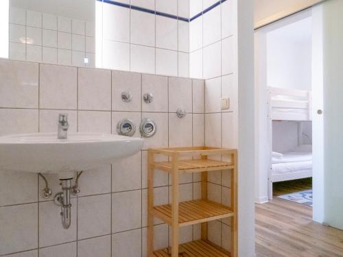 a bathroom with a sink and a mirror and a toilet at Darßer Weg FW 9 in Zingst