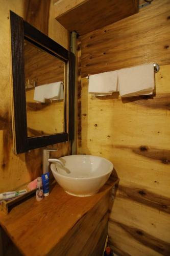 a bathroom with a bowl sink and a mirror at Mu Cang Chai Eco Lodge in Nam San