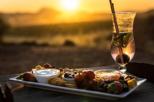 a tray of food on a table with a drink at Camp Kipwe in Twyfelfontein