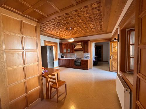 a kitchen with wooden cabinets and a table in it at Villa Sikioti in Ierissos