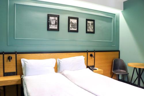 a bedroom with two beds and a blue wall at Borjomi Bridge Hotel in Borjomi