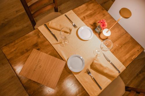 a table with plates and glasses on top of it at Hotel Hostal Estrella in Rupit