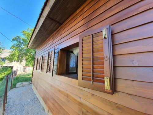 a row of windows on the side of a wooden building at Holiday house with a parking space Perusic, Velebit - 19187 in Perušić