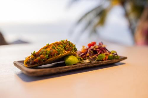 a plate with some food on a table at TropiCoco Beach Resort Koh Phangan in Haad Yao
