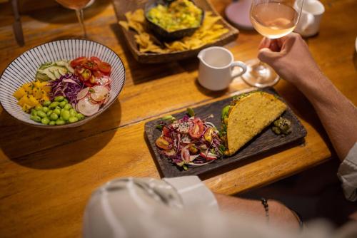 a person sitting at a table with a plate of food at TropiCoco Beach Resort Koh Phangan in Haad Yao