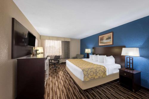 a hotel room with a large bed and a television at Baymont by Wyndham Springfield South Hwy 65 in Springfield