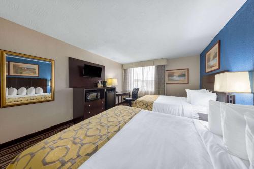 a hotel room with two beds and a television at Baymont by Wyndham Springfield South Hwy 65 in Springfield
