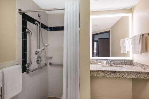 a bathroom with a sink and a shower at AmericInn by Wyndham Two Harbors Near Lake Superior in Two Harbors