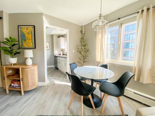 a dining room with a glass table and chairs at 2BR Downtown Convention Center Near Attractions in Seattle