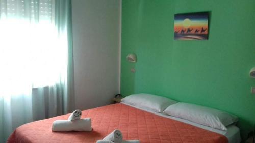 Un pat sau paturi într-o cameră la Albergo Acapulco