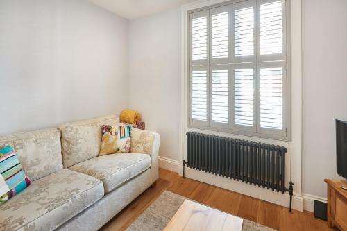 a living room with a couch and a window at Host & Stay - The Old School House in Pickering
