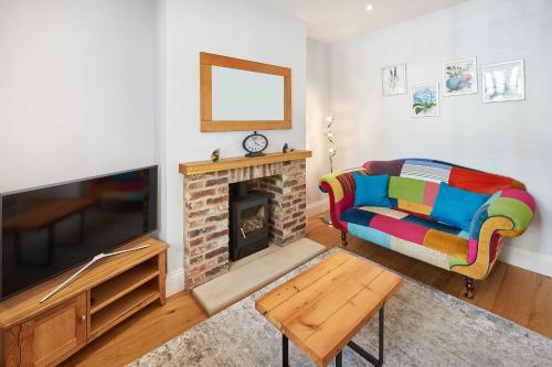 a living room with a couch and a fireplace at Host & Stay - The Old School House in Pickering