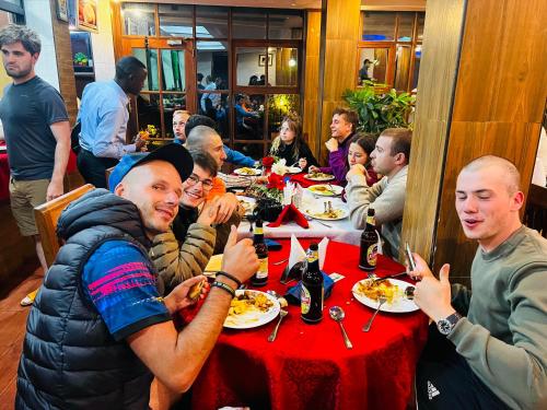 a group of people sitting at a table eating food at Green Mountain Hotel in Arusha