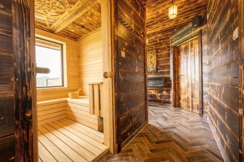 an empty sauna with wooden walls and a window at Sielsko Anielsko in Białka Tatrzanska