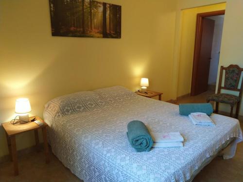 a bedroom with a bed with towels on it at B&B Neverland in Marrùbiu
