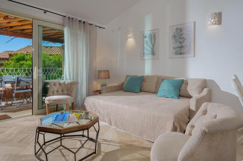a living room with a couch and chairs and a table at Appartamento Botanico - SHERDENIA Luxury Apartments in Santa Marinella