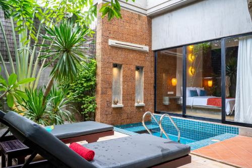 a balcony with a swimming pool in a building at Grange in Siem Reap
