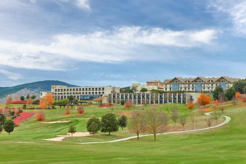a large building in the middle of a green field at Hotel Castillo de Gorraiz&Spa in Gorraiz