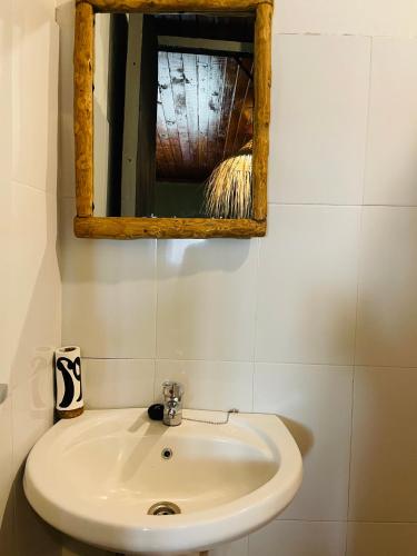 a bathroom with a sink and a mirror at Serengeti Villa in Arusha