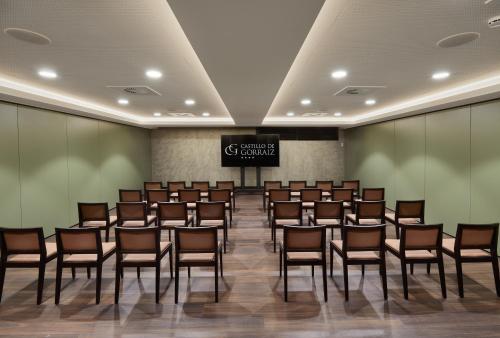 a conference room with chairs and a sign on the wall at Hotel Castillo de Gorraiz&Spa in Gorraiz