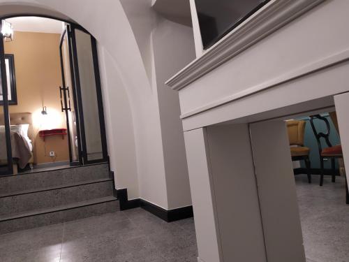 a room with stairs and a mirror and a bed at Pokoje Nad Arkadami in Zamość