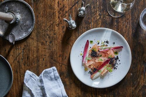 a plate of food on a wooden table at The Bradley Hare in Maiden Bradley