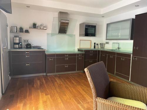 a large kitchen with wooden floors and brown cabinets at Luxusferienwohnung im Herzen der Altstadt von Koblenz in Koblenz