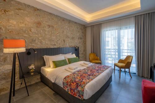 a bedroom with a large bed and a large window at DADYA BORA HOTEL in Emecik