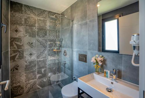 a bathroom with a sink and a shower and a toilet at DADYA BORA HOTEL in Emecik