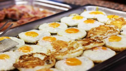 a tray filled with eggs on top of bread at Hotel Tropical in San Antonio