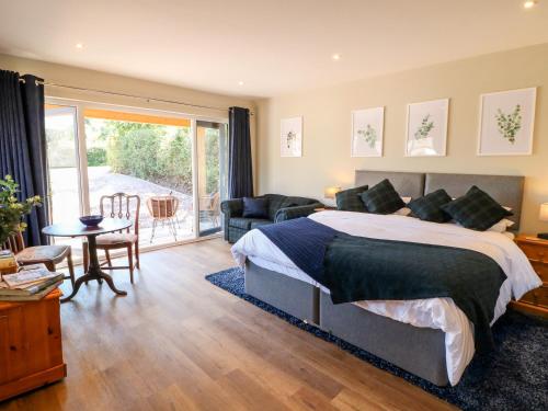 a bedroom with a bed and a living room at The Lodge at Middleton House in Church Leigh